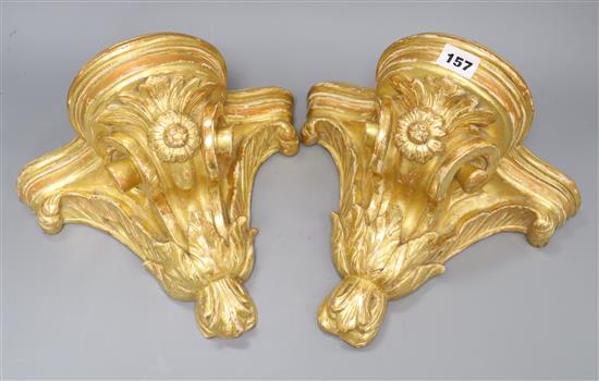 A pair of French gilt carved wood wall brackets width 27cm